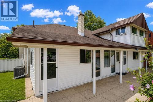 Rear exterior featuring a covered patio with tile flooring and multiple glass panel doors - 182 Avalon Place, Kitchener, ON - Outdoor