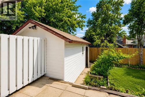 Detached outbuilding with white siding and a brown shingle roof - 182 Avalon Place, Kitchener, ON - Outdoor With Exterior