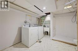 Utility area with white appliances, a freestanding basin sink, and a shower stall - 