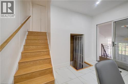 Wood-finish staircase with natural wood handrail - 182 Avalon Place, Kitchener, ON - Indoor Photo Showing Office