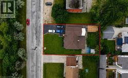 Expansive corner lot featuring a private paved driveway, a large rear yard, and a detached outbuilding - 