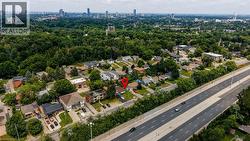 Aerial perspective showcasing the property within a residential area with mature tree coverage - 