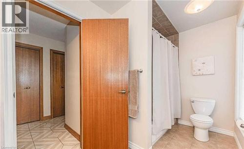 Bathroom with tiled flooring, white toilet, and a shower/tub combination with tiled surround - 28 Walnut Drive, Guelph, ON - Indoor Photo Showing Bathroom
