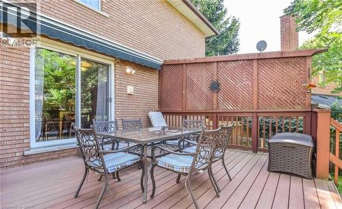 Spacious outdoor deck featuring wood-finish flooring, lattice fencing, and a sliding glass door - 28 Walnut Drive, Guelph, ON - Outdoor With Deck Patio Veranda With Exterior