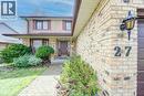 Brick exterior featuring a bay window, dark brown front door, and a paver walkway - 27 Walmer Gardens, London, ON  - Outdoor 