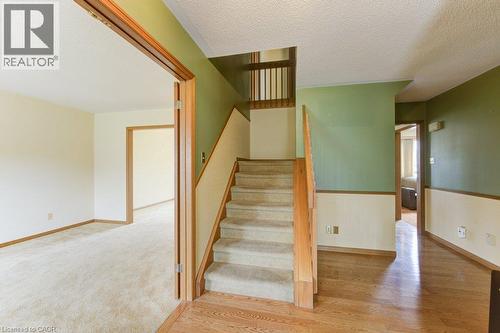 Interior staircase featuring light wood railings and carpeted treads - 27 Walmer Gardens, London, ON - Indoor Photo Showing Other Room