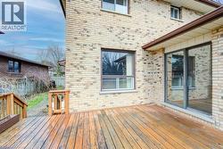 Expansive wood-finish deck with integrated stairs and wood railing - 