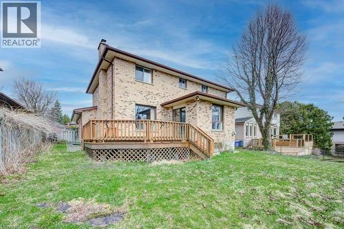 Brick exterior residence featuring multiple windows and a prominent chimney - 27 Walmer Gardens, London, ON - Outdoor With Deck Patio Veranda