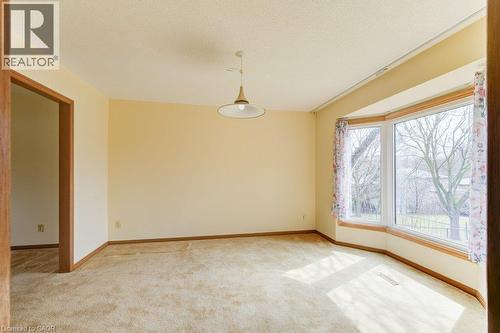 Room featuring a prominent bay window with wood trim - 27 Walmer Gardens, London, ON - Indoor Photo Showing Other Room