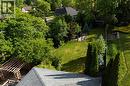 Expansive rear yard featuring a manicured lawn, established landscaping, a wooden pergola, and a visible storage shed - 907 Doon Village Road, Kitchener, ON  - Outdoor 