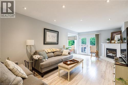 Living area featuring wood-finish flooring, recessed lighting, and light gray wall paint - 907 Doon Village Road, Kitchener, ON - Indoor Photo Showing Living Room With Fireplace