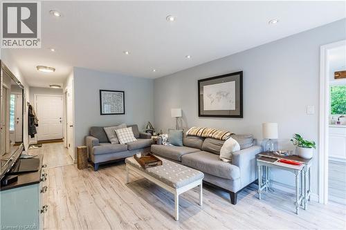 Bright, open-concept living area showcasing light wood-finish flooring, soft blue-gray walls, and recessed ceiling lighting - 907 Doon Village Road, Kitchener, ON - Indoor Photo Showing Living Room