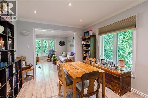 Open-concept dining area featuring wood-finish flooring, recessed lighting, and a large window with privacy blinds - 907 Doon Village Road, Kitchener, ON - Indoor Photo Showing Dining Room