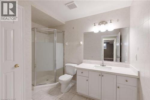 Spa-inspired primary bathroom featuring a spacious vanity with dual sink configuration, ample storage cabinetry, and brushed nickel hardware - 907 Doon Village Road, Kitchener, ON - Indoor Photo Showing Bathroom