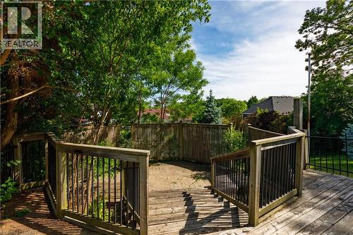 Outdoor wood deck featuring integrated stairs and dark-toned metal balusters - 907 Doon Village Road, Kitchener, ON - Outdoor With Deck Patio Veranda