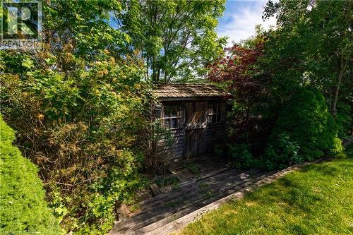 Rustic storage shed featuring wood siding and a shake roof - 907 Doon Village Road, Kitchener, ON - Outdoor