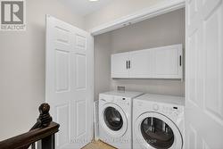 3rd floor laundry room with storage cabinets - 