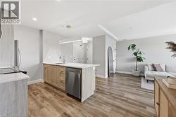Open-concept living space with wood-finish flooring - 