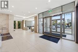 Lobby entrance featuring large format tile flooring and full-height glass doors - 