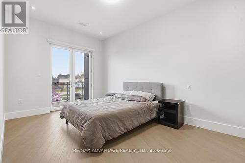 Primary bedroom with access to the balcony - 207 - 1705 Fiddlehead Place, London North (North R), ON - Indoor Photo Showing Bedroom