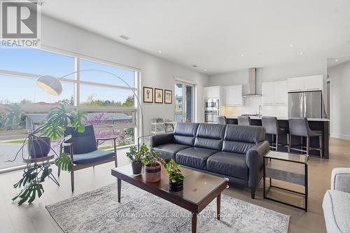 Expansive floor to ceiling windows - 207 - 1705 Fiddlehead Place, London North (North R), ON - Indoor Photo Showing Living Room