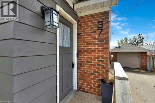 Exterior featuring horizontal siding, brick accents, and an entry door with a multi-pane glass insert - 371 Ottawa Street S, Kitchener, ON - Indoor Photo Showing Other Room