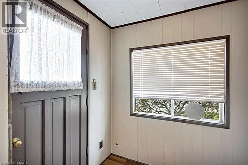 Entryway featuring a panel door with a window, vertical wood paneling, and wood-finish flooring - 371 Ottawa Street S, Kitchener, ON - Indoor Photo Showing Other Room