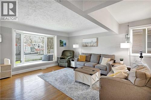 Living area featuring a large bay window with integrated window seating, hardwood flooring, and light-toned walls - 371 Ottawa Street S, Kitchener, ON - Indoor Photo Showing Living Room