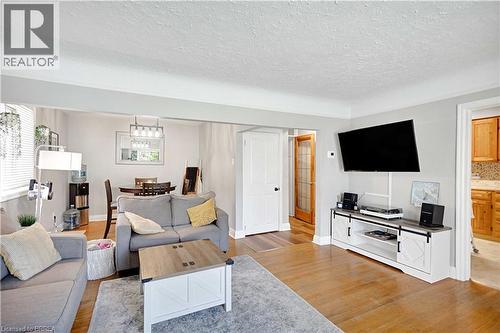Living area featuring wood-finish flooring, light gray wall paint, and white trim - 371 Ottawa Street S, Kitchener, ON - Indoor Photo Showing Living Room