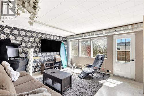 Living area featuring a distinctive floral accent wall - 371 Ottawa Street S, Kitchener, ON - Indoor Photo Showing Other Room