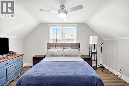Bright bedroom featuring wood-finish flooring, a contemporary ceiling fan with integrated lighting, and a double window - 371 Ottawa Street S, Kitchener, ON - Indoor Photo Showing Bedroom
