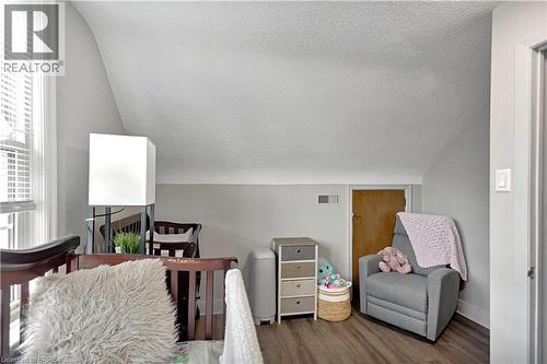 Room featuring sloped ceilings, wood-finish flooring, and a window with blinds - 371 Ottawa Street S, Kitchener, ON - Indoor With Fireplace