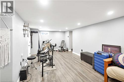 Spacious interior room featuring light gray walls, recessed lighting, and wood-finish flooring - 371 Ottawa Street S, Kitchener, ON - Indoor