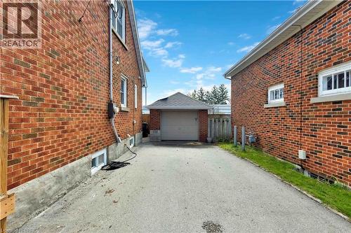 Paved driveway leading to a detached garage - 371 Ottawa Street S, Kitchener, ON - Outdoor With Exterior