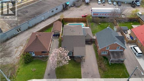 Aerial perspective showcasing two residential properties, each featuring a private driveway, pitched shingle roof, and a fenced backyard - 371 Ottawa Street S, Kitchener, ON - Outdoor
