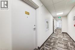 Entry door with polished metal hardware and a gold-toned unit number - 