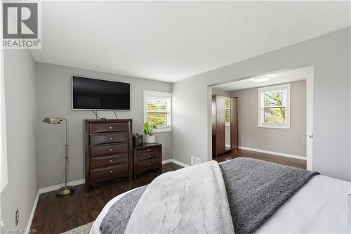 Neutral gray walls complementing dark wood-finish flooring - 60 Avenue Road, Cambridge, ON - Indoor Photo Showing Bedroom