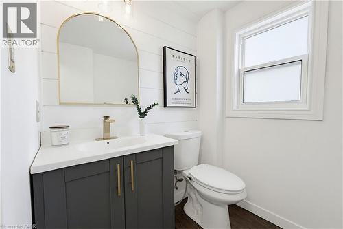 Modern bathroom featuring wood-finish flooring and shiplap-style wall paneling - 60 Avenue Road, Cambridge, ON - Indoor Photo Showing Bathroom
