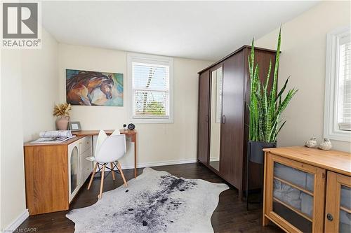 Room with dark wood-finish flooring, light-toned walls, and a window with white blinds - 60 Avenue Road, Cambridge, ON - Indoor