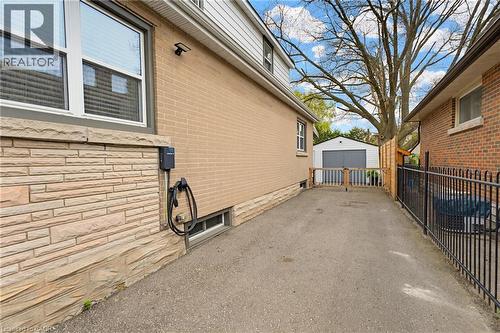 Paved side driveway leading to a detached garage - 60 Avenue Road, Cambridge, ON - Outdoor With Exterior