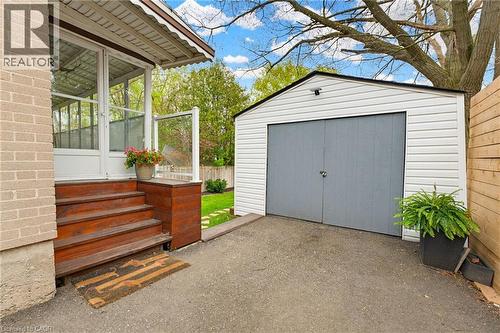 Detached garage with horizontal siding and double panel doors - 60 Avenue Road, Cambridge, ON - Outdoor With Exterior