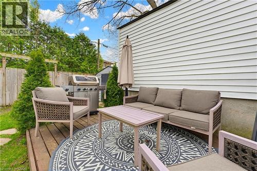 Outdoor wood-finish deck with mature evergreen plantings and perimeter fencing - 60 Avenue Road, Cambridge, ON - Outdoor With Deck Patio Veranda