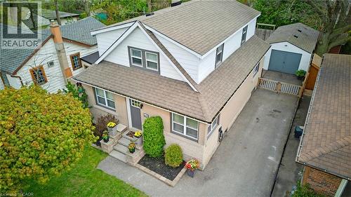 Two-story residence featuring light brick and white siding, a multi-gabled roof, and a front entry with stone steps - 60 Avenue Road, Cambridge, ON - Outdoor