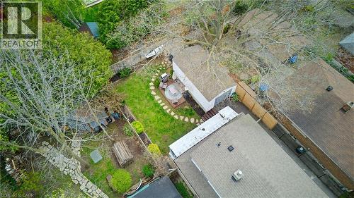 Expansive backyard featuring a manicured lawn, established trees, and a stone-paver pathway leading to a patio area - 60 Avenue Road, Cambridge, ON - Outdoor With View