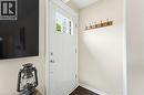 Entryway featuring a white paneled door with glass inserts, wood-finish flooring, and a wall-mounted coat rack - 60 Avenue Road, Cambridge, ON  - Indoor Photo Showing Other Room 