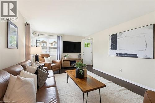 Living area featuring dark wood-finish flooring with a light area rug - 60 Avenue Road, Cambridge, ON - Indoor Photo Showing Living Room