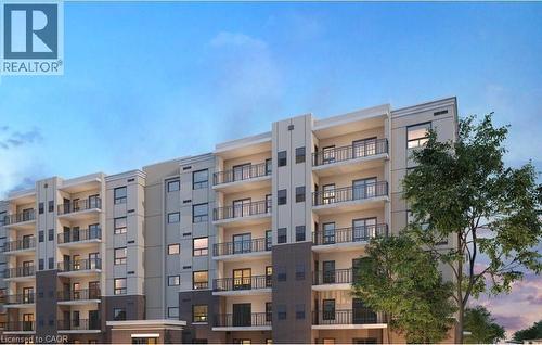 Multi-story building facade featuring numerous private balconies with black metal railings - 3370 Stella Crescent Unit# 235, Windsor, ON - Outdoor With Balcony With Facade