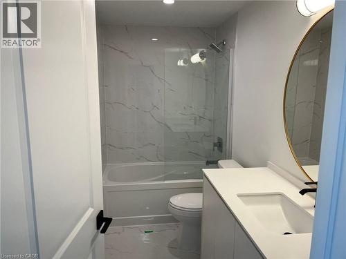 Bathroom featuring a tiled shower and tub combination with a clear glass enclosure - 3370 Stella Crescent Unit# 235, Windsor, ON - Indoor Photo Showing Bathroom