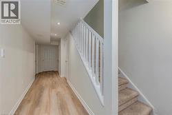 Hallway featuring wood-finish flooring and recessed lighting - 