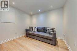 Room featuring light wood-finish flooring, recessed ceiling lights, and white baseboards - 